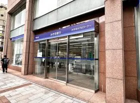 出入口近くのみずほ銀行を通過、横断歩道を渡る（直進）